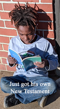 preteen boy sits cross-legged on porch reading book. Caption reads "Just got his own New Testament." 