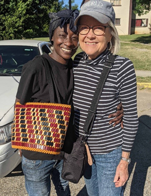 Two women side hug