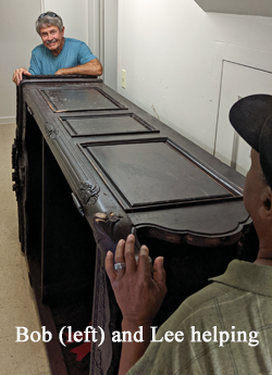 Bob and Lee helping to move a large bookcase