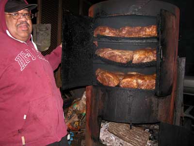 minding the smoker with meat 